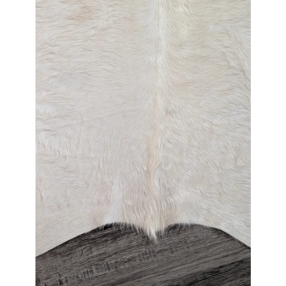 Large cowhide rug in white ivory with soft natural fur texture and unique characteristics perfect for beautiful rugs