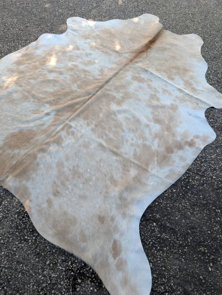 Large cowhide rug in natural white and tan with soft texture adds rustic charm to your space with beautiful rugs