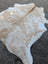 Large cowhide rug in natural white and tan with soft texture adds rustic charm to your space with beautiful rugs