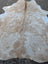 Large cowhide rug in natural tan and white with soft texture adding rustic charm to beautiful rugs