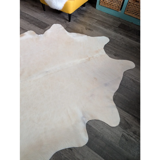 Large cowhide rug with pale beige natural white color and unique characteristics perfect for beautiful rugs collection