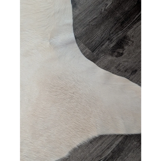Cream-colored large cowhide rug with soft texture and unique characteristics in pale beige for beautiful rugs