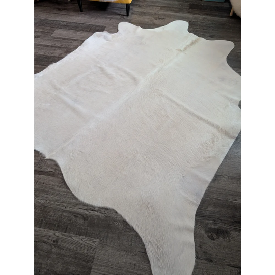 Large cowhide white ivory rug with fluffy texture and unique irregular edges perfect for beautiful rugs collection