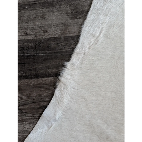 Large cowhide white ivory rug with soft natural fur texture and unique characteristics for beautiful rugs
