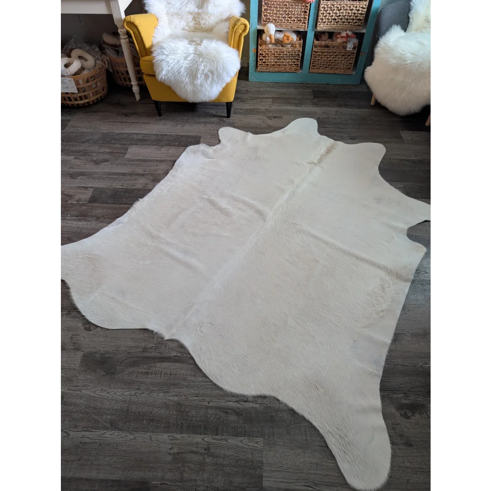 Large cowhide rug in white ivory with plush texture and unique characteristics perfect for beautiful rugs collection