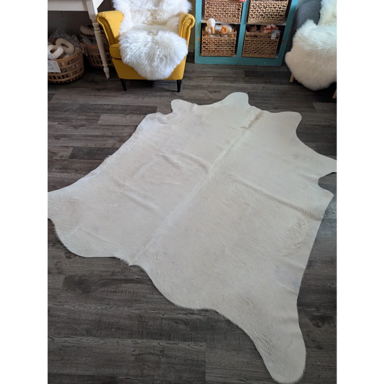 Large cowhide rug in white ivory with plush texture and unique characteristics perfect for beautiful rugs collection