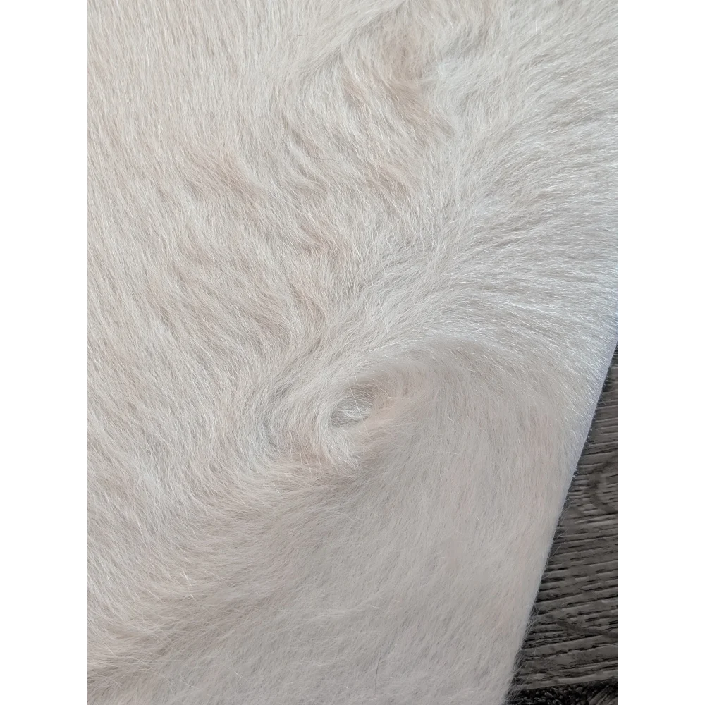 Large cowhide white ivory faux fur rug with soft plush texture and unique characteristics for beautiful rugs