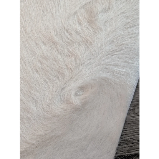 Large cowhide white ivory faux fur rug with soft plush texture and unique characteristics for beautiful rugs
