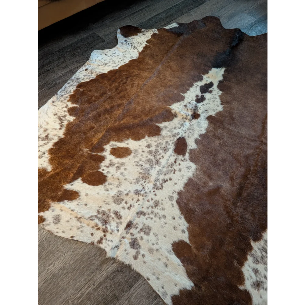 Large brown and white cowhide rug with natural fur texture showcasing unique characteristics for beautiful rugs