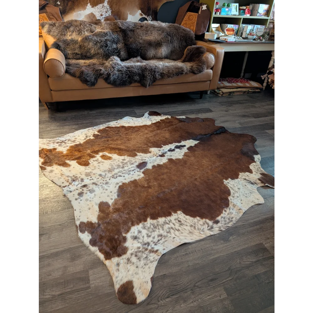 Large cowhide rug featuring beautiful brown and white patterns with unique natural characteristics perfect for decor