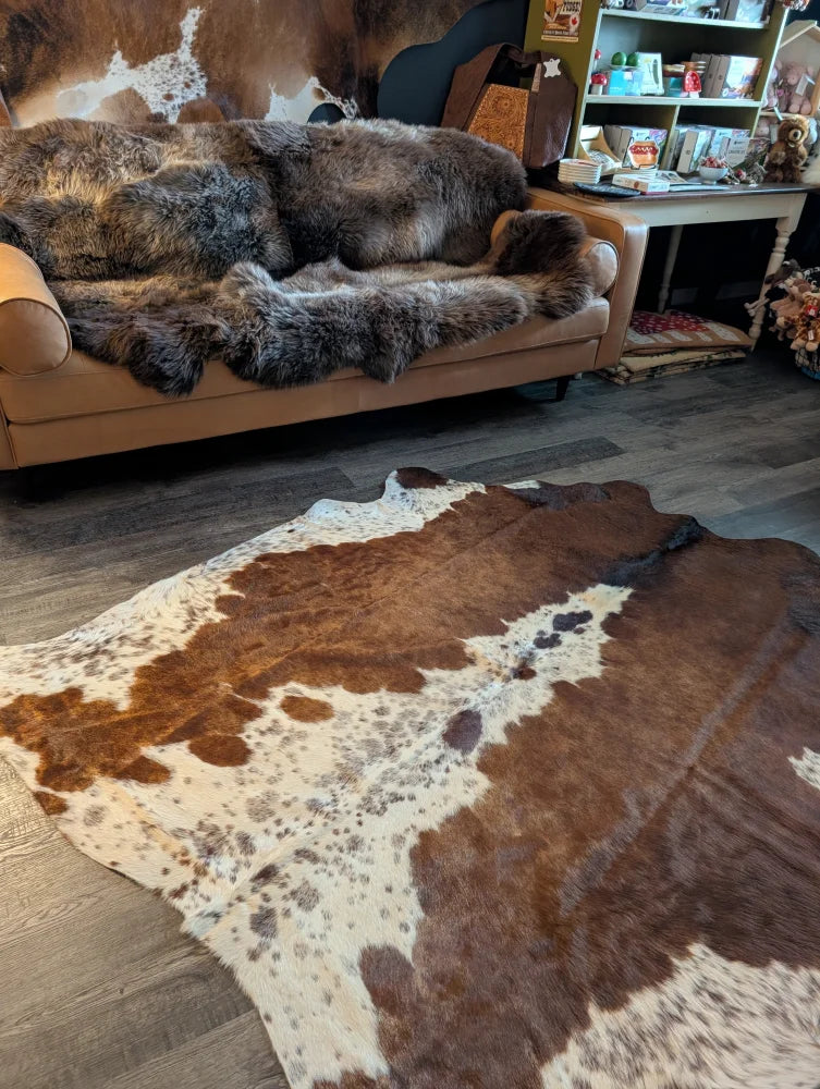 Beautiful large cowhide rug with brown and white natural fur texture showcasing unique characteristics