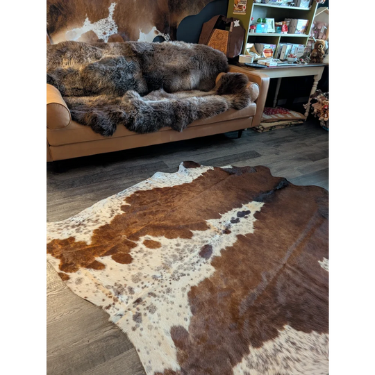 Beautiful large cowhide rug with brown and white natural fur texture showcasing unique characteristics