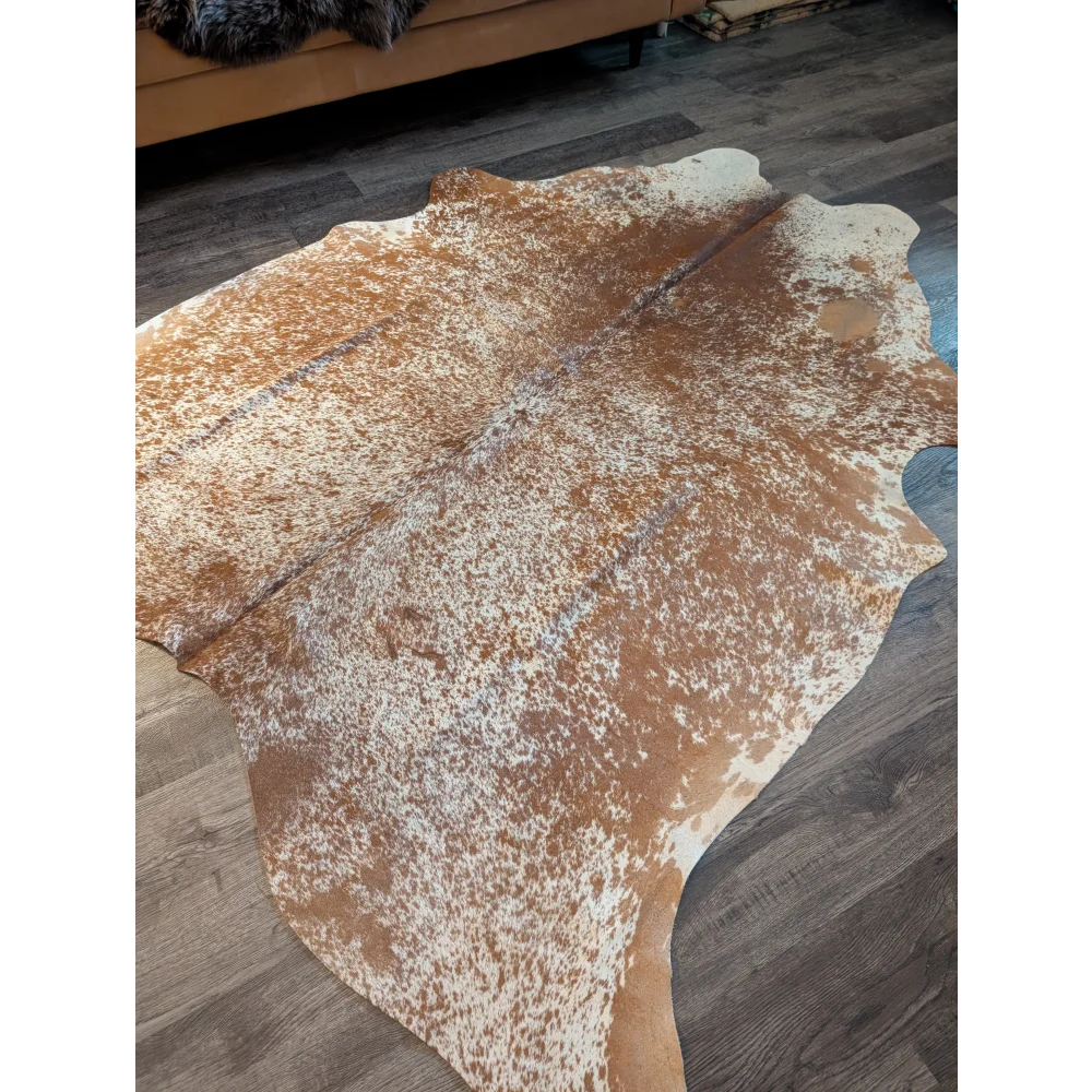Large cowhide brown and white speckled rug with beautiful irregular edges showing unique characteristics