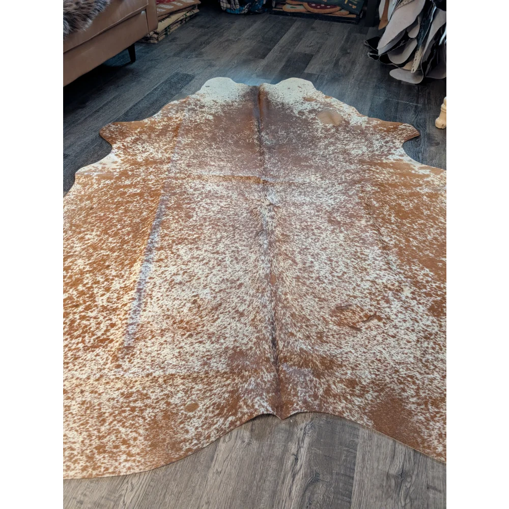 Brown and white speckled large cowhide rug with natural irregular edges perfect for beautiful rugs with unique characteristics