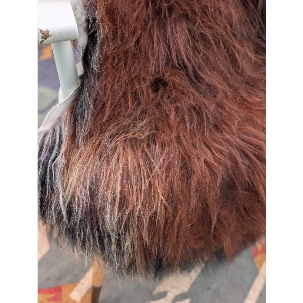 A plush extra large long wool icelandic sheepskin vest in rich brown and black tones with soft natural texture