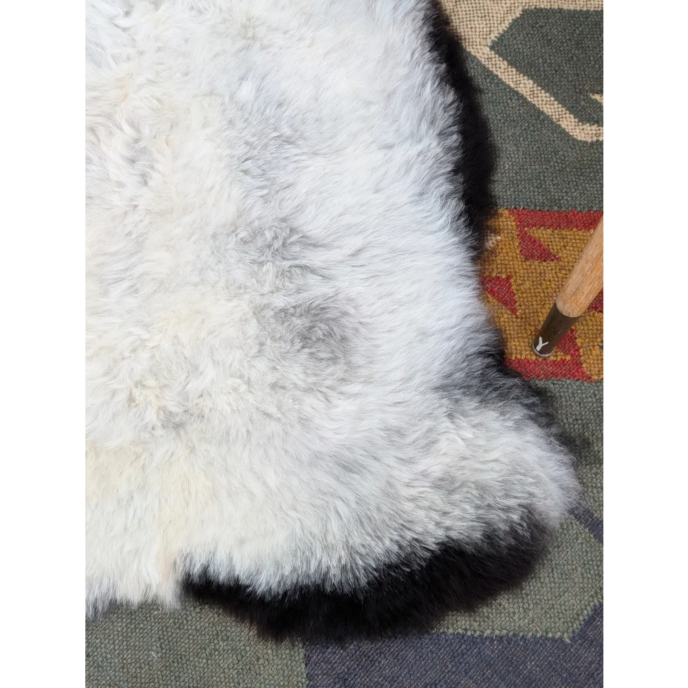 Large 42 x 27 inch icelandic sheepskin rug with white and gray long wool and black border by angus oliver