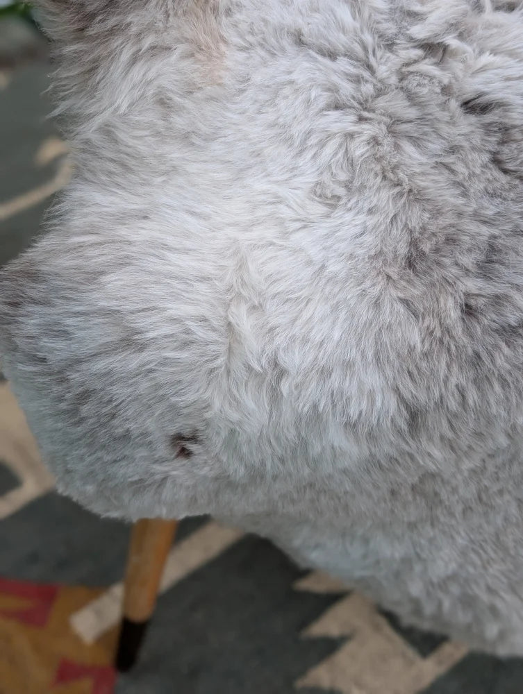A plush gray fluffy icelandic sheepskin with long wool by angus oliver measuring 44 x 33 inches