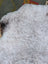 A large icelandic sheepskin rug with long wool and plush white curly fur by angus oliver measuring 43 x 35 inches