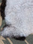 A plush large icelandic sheepskin rug with long wool in white and black by angus oliver measuring 43 x 35 inches
