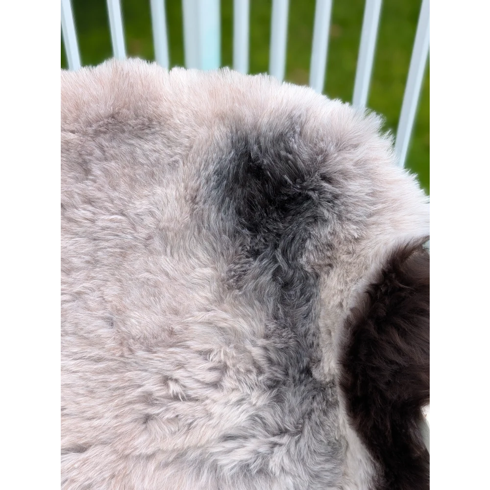 A soft icelandic sheepskin rug with long wool in natural gray and white gradient by angus oliver sized 43.5 x 33 inches