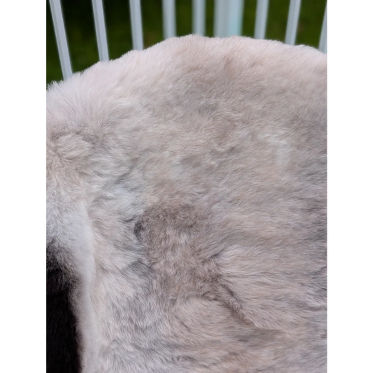 A soft light gray large icelandic sheepskin throw with long wool and plush texture by angus oliver