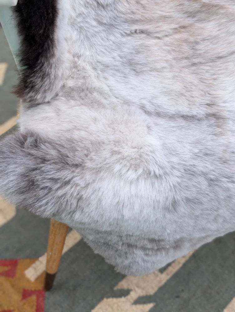 A large gray icelandic sheepskin throw with soft long wool and subtle gradient perfect for cozy decor by angus oliver