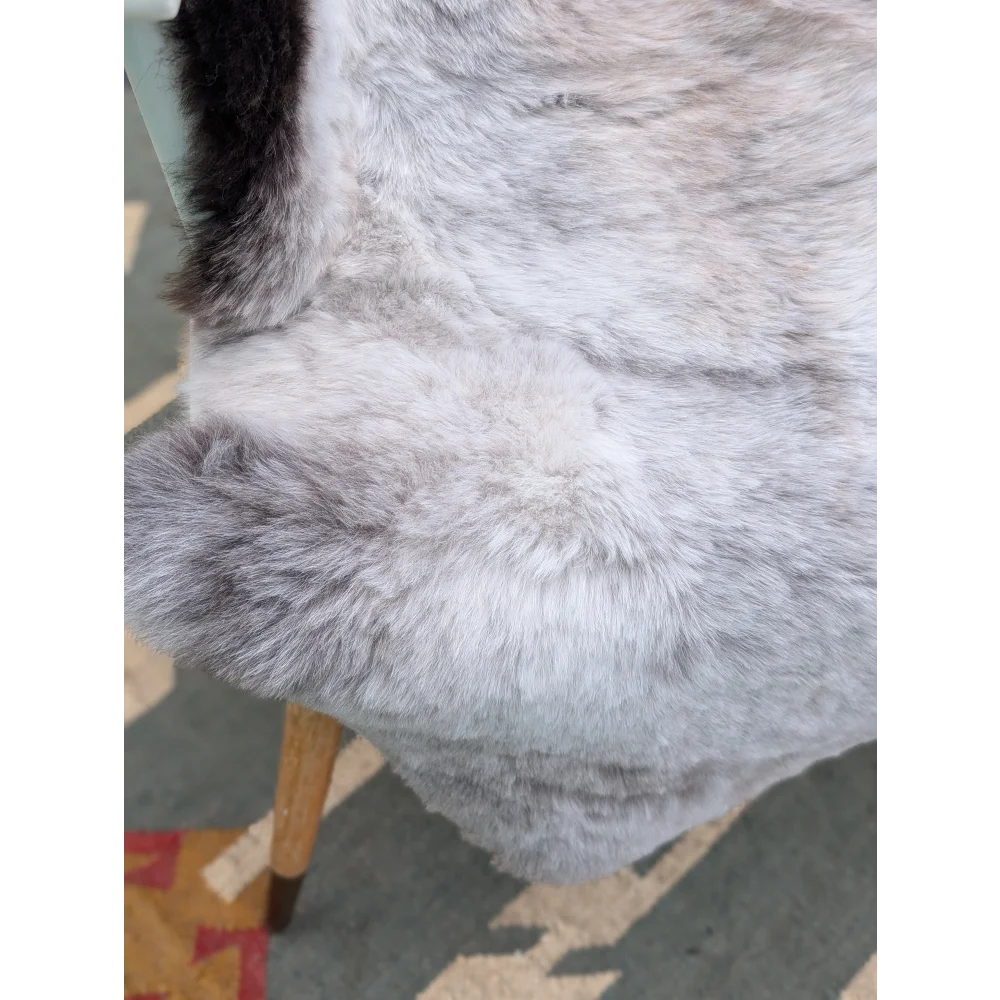 A large gray icelandic sheepskin throw with soft long wool and subtle gradient perfect for cozy decor by angus oliver
