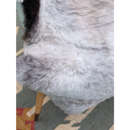 A large gray icelandic sheepskin throw with soft long wool and subtle gradient perfect for cozy decor by angus oliver