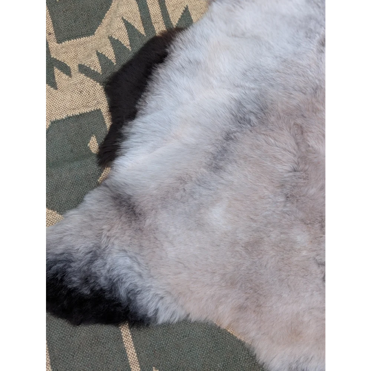 A large 44 x 31 inch icelandic sheepskin rug with soft long wool in gray and black by angus oliver