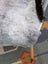 A plush gray faux fur icelandic sheepskin chair cover with soft dense texture and black tail accent by angus oliver