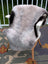 A large 44 x 31 icelandic sheepskin throw with light gray and black long wool icelandic fur on a white chair by angus oliver