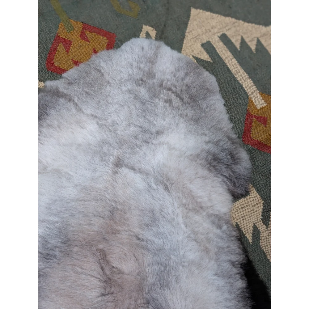 A soft light gray angus oliver icelandic sheepskin rug with long wool icelandic natural fluffy texture and subtle shade variations