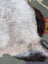 A large 43 x 31 inch icelandic sheepskin rug with long wool and a natural gray to brown gradient by angus oliver