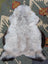 A soft fluffy gray and black long wool icelandic sheepskin rug with natural edges from angus oliver