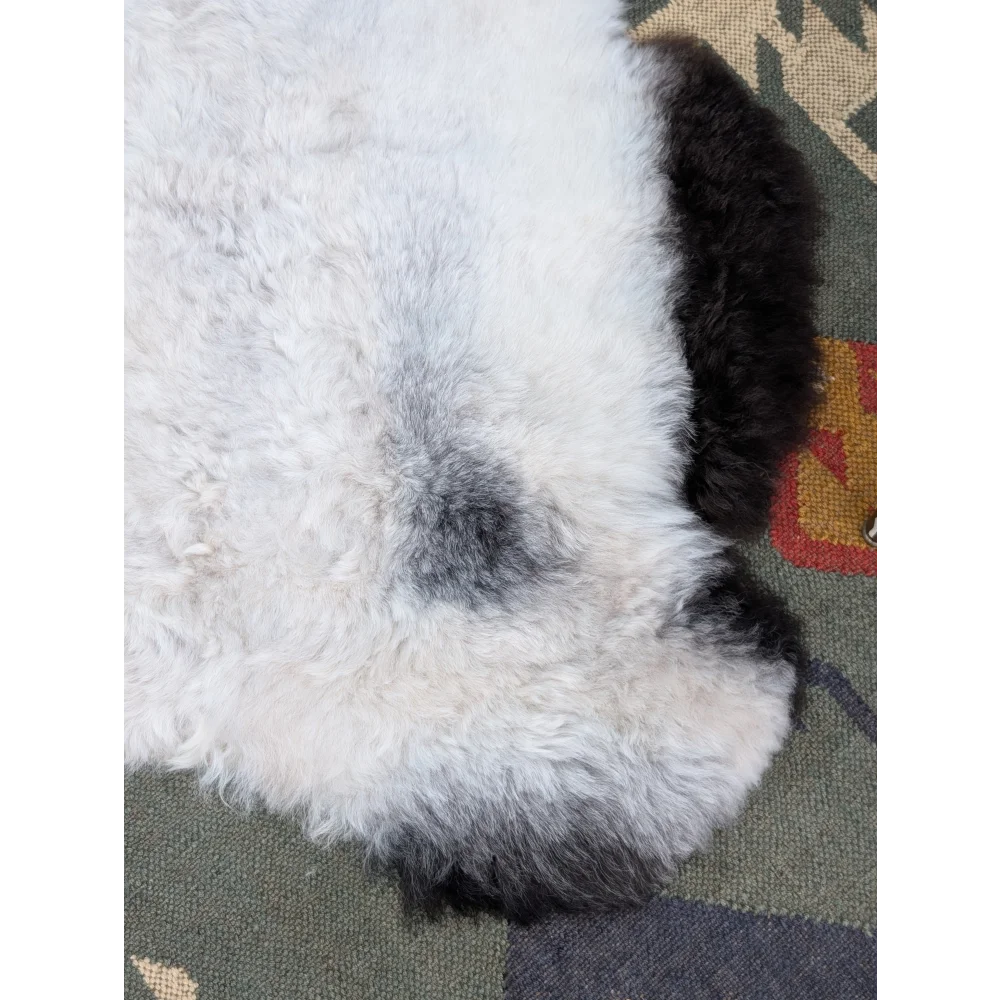 A plush white and black long wool icelandic sheepskin rug with soft curly texture from angus oliver