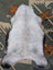 A plush icelandic sheepskin rug with long wool in white and gray by angus oliver, sized 44 x 27 inches