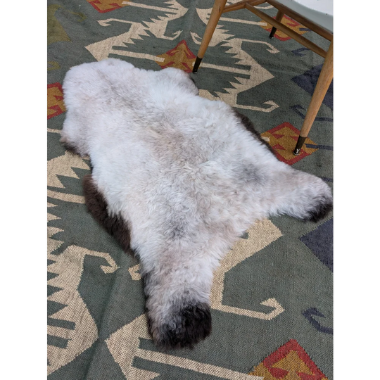 A fluffy 44 x 27 inch large icelandic sheepskin rug with long wool icelandic texture in white to dark brown by angus oliver