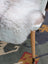 White fluffy fur chair cover with soft plush texture made of natural long wool icelandic sheepskin by angus oliver