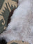 A large 44x27 inch icelandic sheepskin rug with long wool icelandic soft fluffy white fur and subtle gray patches by angus oliver