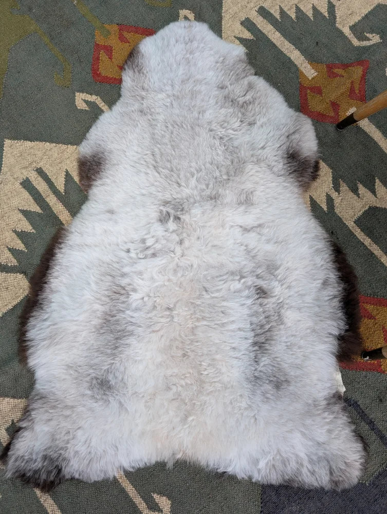 A large icelandic sheepskin rug in soft gray with long wool icelandic texture by angus oliver measuring 44.5 x 31 inches