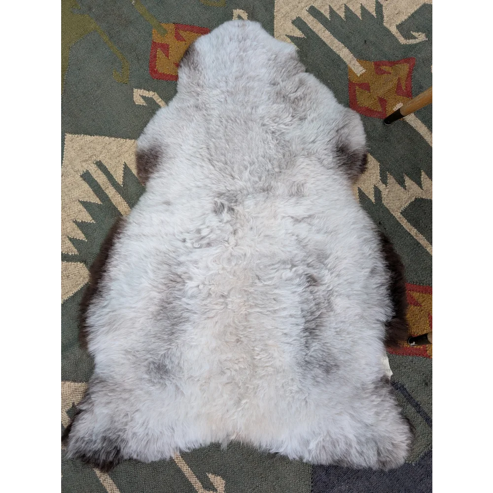 A large icelandic sheepskin rug in soft gray with long wool icelandic texture by angus oliver measuring 44.5 x 31 inches