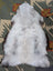 A large icelandic sheepskin rug in soft gray with long wool icelandic texture by angus oliver measuring 44.5 x 31 inches