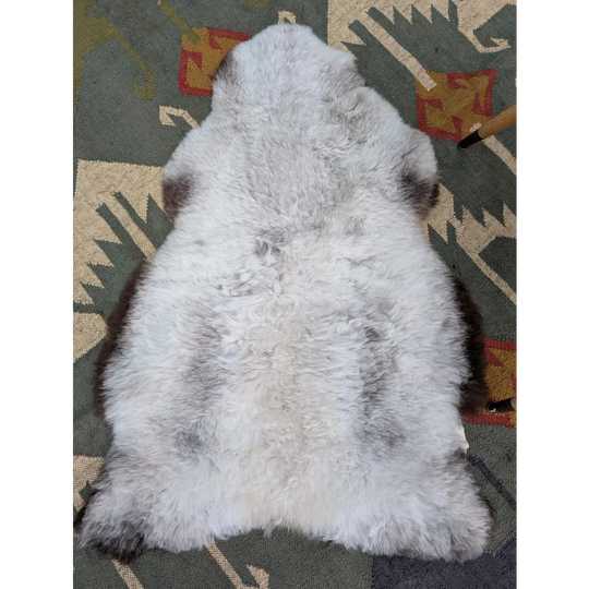 A large icelandic sheepskin rug in soft gray with long wool icelandic texture by angus oliver measuring 44.5 x 31 inches