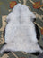 A soft curly white and black angus oliver icelandic sheepskin rug with long wool and fluffy natural texture