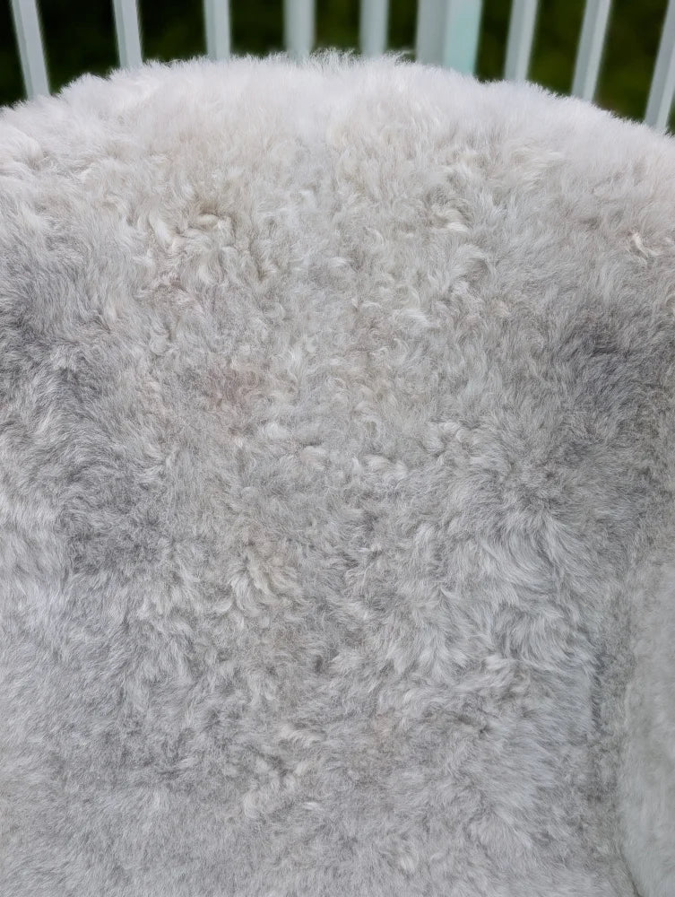 A large soft gray icelandic sheepskin throw with long wool icelandic curly texture by angus oliver