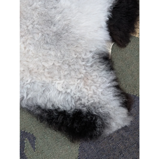 A large icelandic sheepskin rug with plush long wool icelandic fur in white and black by angus oliver