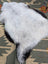 A large 44 x 30 inch soft fluffy white and black icelandic sheepskin rug with natural edges by angus oliver