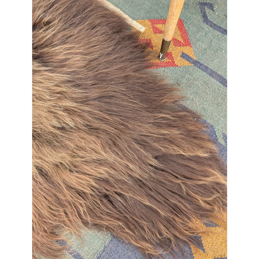 Thick shaggy brown icelandic sheepskin rug with long wool icelandic texture by angus oliver measuring 59 x 37 inches