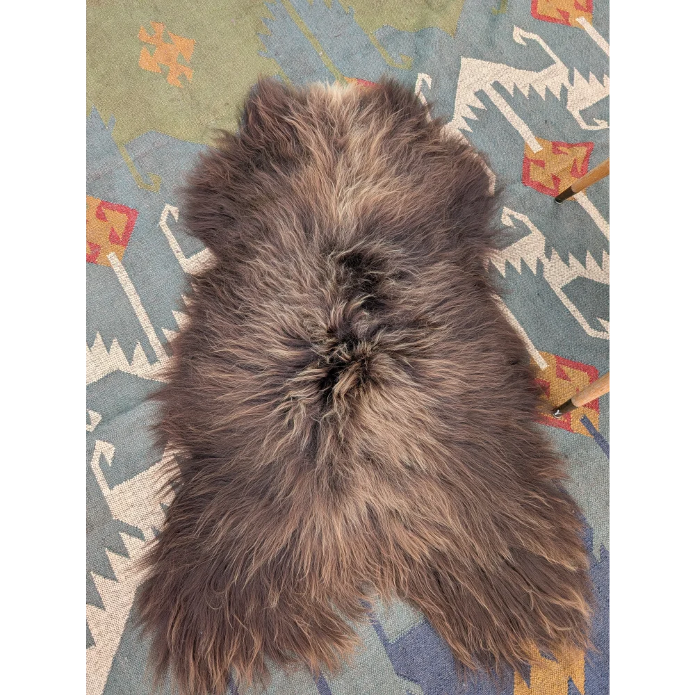 A plush grey icelandic sheepskin rug with long wool and natural texture from angus oliver measuring 59 by 37 inches