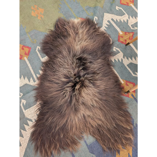 A plush grey icelandic sheepskin rug with long wool and natural texture from angus oliver measuring 59 by 37 inches